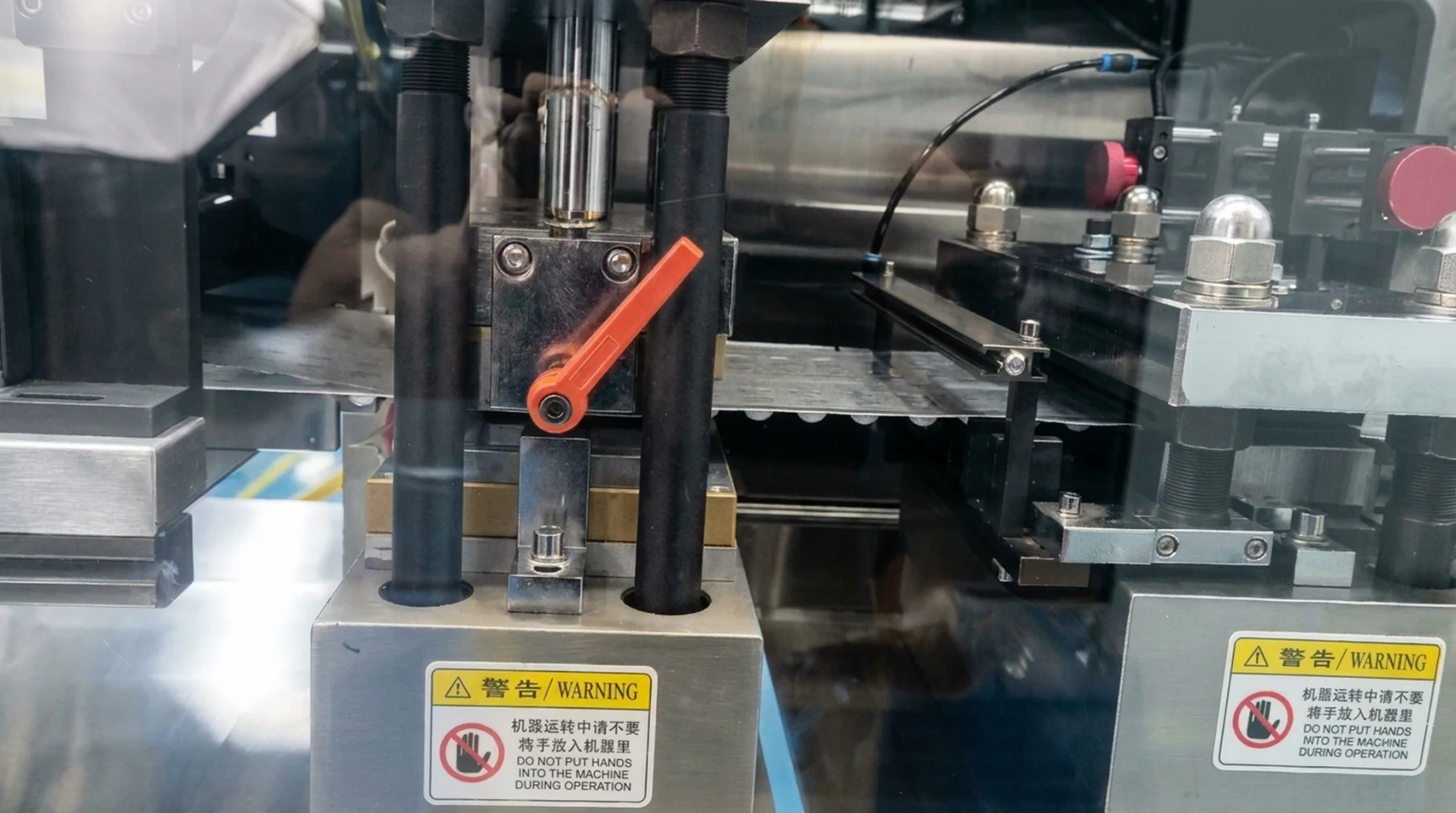 Metal guides and a processing mechanism along the film path
